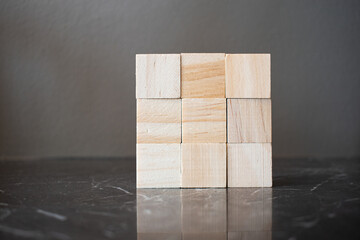 Nine wooden blocks arranged in 3 x 3 cube