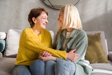 Happy mother and daughter sharing news and jokes communicating