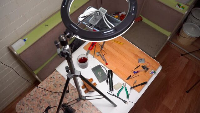 Closeup view of simple electric circuit, breadboard with electrical components, diode, resistors, soldering electrical colored cables and wires. Hand soldering station. Electronic parts