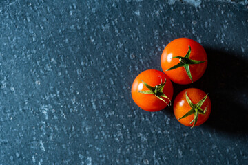 Cherry tomatoes on a black background. Top view. Copy space