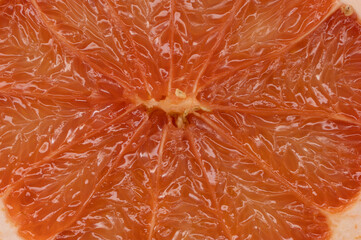 A beautiful macro photograph of the inside of a grapefruit with stunning textured effect showing the healthy juice that is good for lifestyle and heart and body and mind
