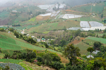 Dramatic image of a small agricultural village in the Caribbean mountains of the Dominican Republic with hills full of farming fields.