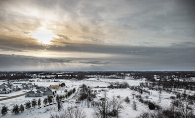 New residential homes construction next to horse farms and fields in rural Kentucky after snowfall