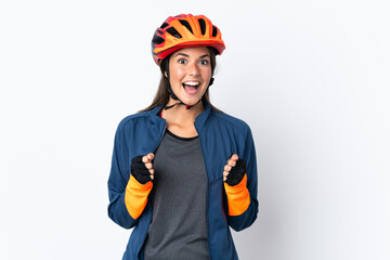 Young cyclist brazilian girl isolated on white  background celebrating a victory in winner position
