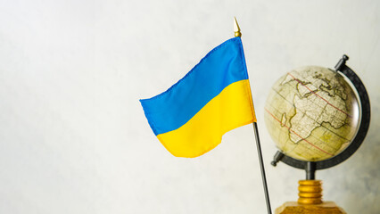Globe and national flag of Ukraine. Ukraine in geopolitics, Russia's invasion of the territory of...