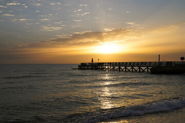 Beautiful sunrise over the ocean with a footbridge in Makadi Bay, Egypt