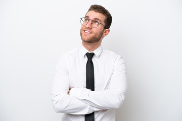 Young business caucasian man isolated on white background looking up while smiling