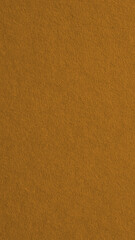 The surface of bright brown cardboard. Textured pasteboard. Mobile phone wallpaper. Paper texture with cellulose fibers. Vertical paperboard background. Macro