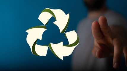 hand holding green recycle symbol
