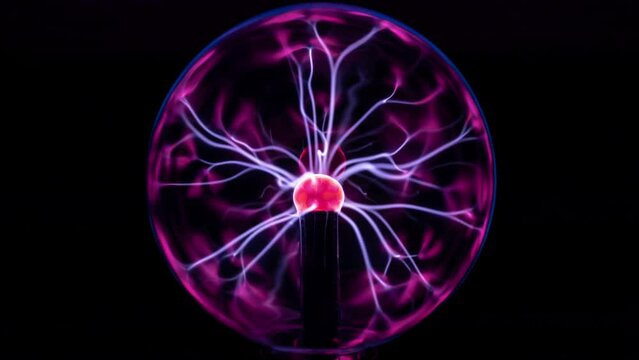 Tesla energy plasma ball lit over black background reflecting .