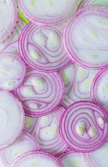 onion macro,pattern of the chopped red onion, red onion slices as a background, texture, nutrition background, top view.