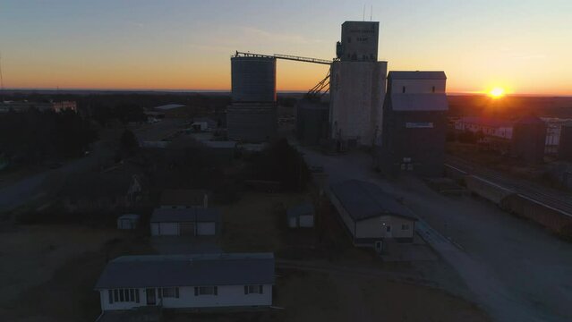 Small town grain elevator aerial at sunrise