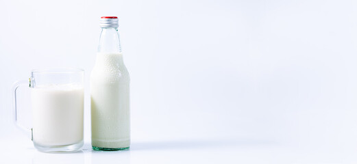 milk,natural milk in jug and glass isolated on white background closeup