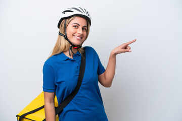 Young caucasian woman with thermal backpack isolated on white background pointing finger to the side
