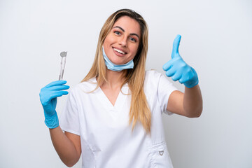 Dentist woman holding tools isolated on white background with thumbs up because something good has happened