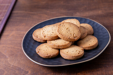 Freshly baked cookie biscuits with cumin spice on a plate. Jeera biscuits snacks, Indian cuisine dessert.