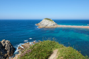 Cliffs surrounded by clear waters and blue skies