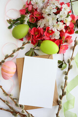 greeting card layout. bouquet of spring flowers, willow twigs and colorful Easter eggs 