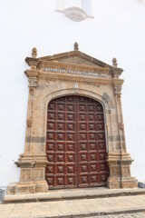 Fototapeta na wymiar Garachico, Tenerife, Canary Islands, Spain, February 23, 2022: One of the access doors of the Church of Santa Ana. Garachico, Tenerife, Spain