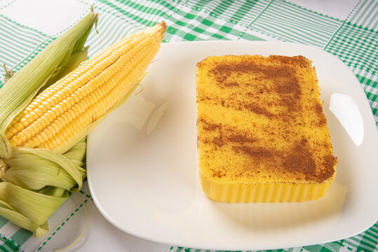Brazilian Cural, candy corn and corn arranged on a table with a green and white tablecloth, dark background, selective focus.