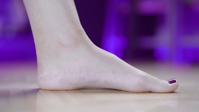 Female foot stretching toe exercise arch muscles close-up 4K