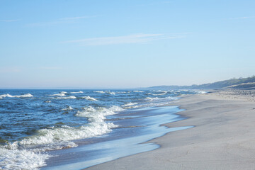 Fototapeta na wymiar Seascape, the photo shows a sunny day, waves and sand