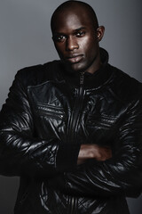 Obraz premium Masculine confidence. A handsome african man modeling clothes in studio.