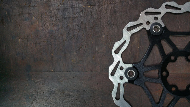 bike brake disc - photo bicycle parts close up on a dark wood background
