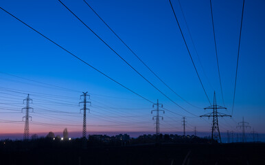power line pylons after sunset