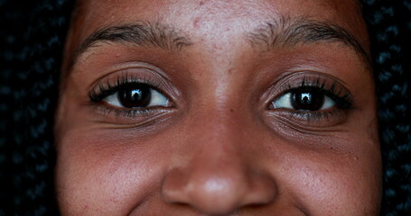 Smiling happy black African american young woman eyes face looking at camera