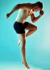 No shackles can hold me down. Studio shot of a handsome young man jumping against a blue background.