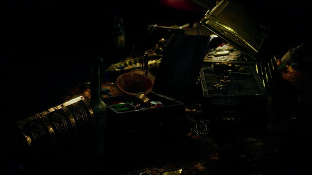 treasures in a dark cave with coins diamonds and gold