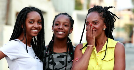 Mother and teen daughters laughing together. Mom and girls gossiping