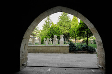 Ancient graveyard, ottoman governments tombstone by taking photo behind arch structural building and column