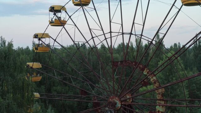The abandoned ferris wheel in Pripyat. View on Chernobyl Nuclear Power Plant. Destroyed buildings. Chernobyl Video from the drone. High quality 4k footage