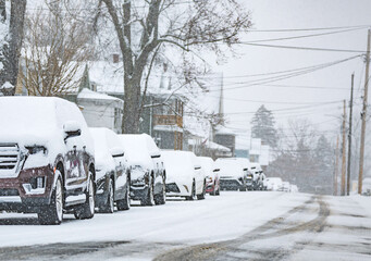 Snow storm plow, small USA town road covered in snow, during snow storm, cars traffic, bad weather...
