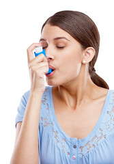 Luckily she had her inhaler with her. Studio shot of an attractive young woman using an asthma...