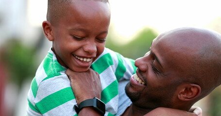 Father tickling child son. African black ethnicity parent and kid bonding together laughing and...