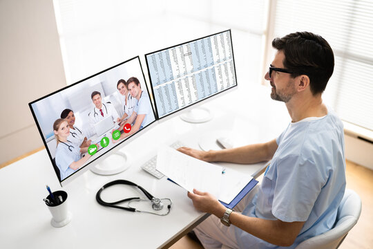 Male Doctor Video Conferencing On Computer