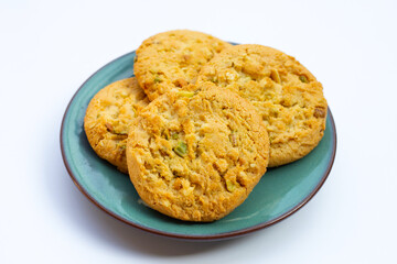 Pistachio and almond cookies on white background.