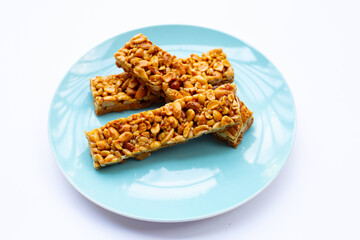 Peanut bar with almonds on white