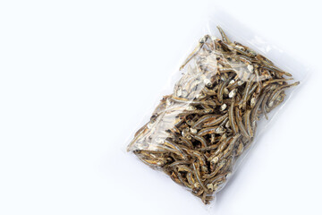 Dried anchovy in plastic bag on white background