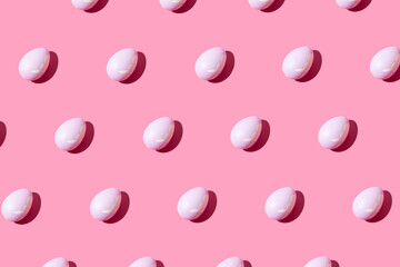 Pattern made of pink eggs on pastel pink background. Minimal Easter or food concept.