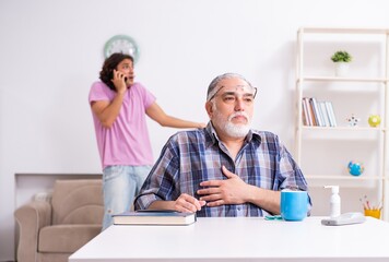 Young student and his old grandpa at home