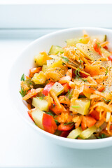 Raw salad with carrot, pickled cucumber, pepper, bowl, healthy diet, suitable for vegans and vegetarians