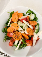 Raw salad in a bowl with carrot, parsnip, rocket, pepper, vegan, vegetarian, healthy diet