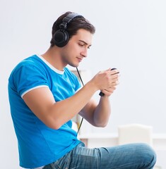 Young handsome man singing karaoke at home