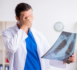 Young male doctor working in the clinic