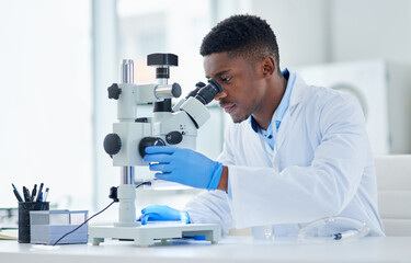What an interesting find. Cropped shot of a focused young male scientist looking at test samples...