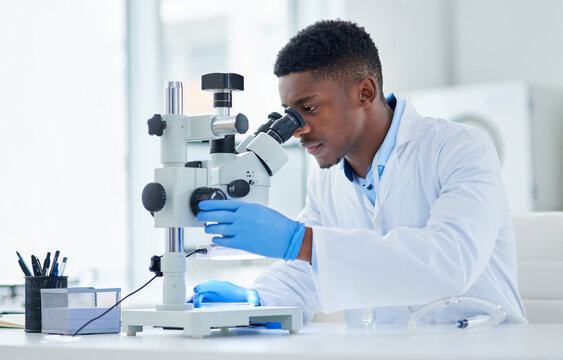 What an interesting find. Cropped shot of a focused young male scientist looking at test samples through a microscope inside of a laboratory during the day.